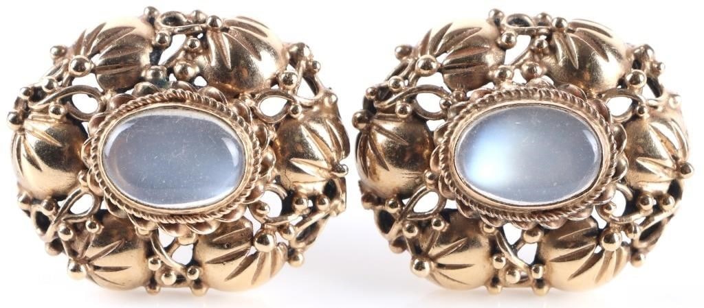 ORNATE 14K YELLOW GOLD LADIES CLIP-ON EARRINGS: Ornate 14k yellow gold ladies clip on earrings. The piece consists of a border of twisting leaves around a smoky glass center stone. Stone Type: Glass Weight: 30.06 grams Size: 28.5mm Condition: See