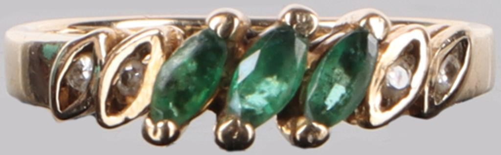 14K MARQUISE CUT EMERALD THREE STONE LADIES RING: Dainty 14K marquise cut emerald three stone ladies ring. There are three marquise cut emeralds in the center with two very small diamonds on each side creating an elegant look. Stone Type: Emerald Wei
