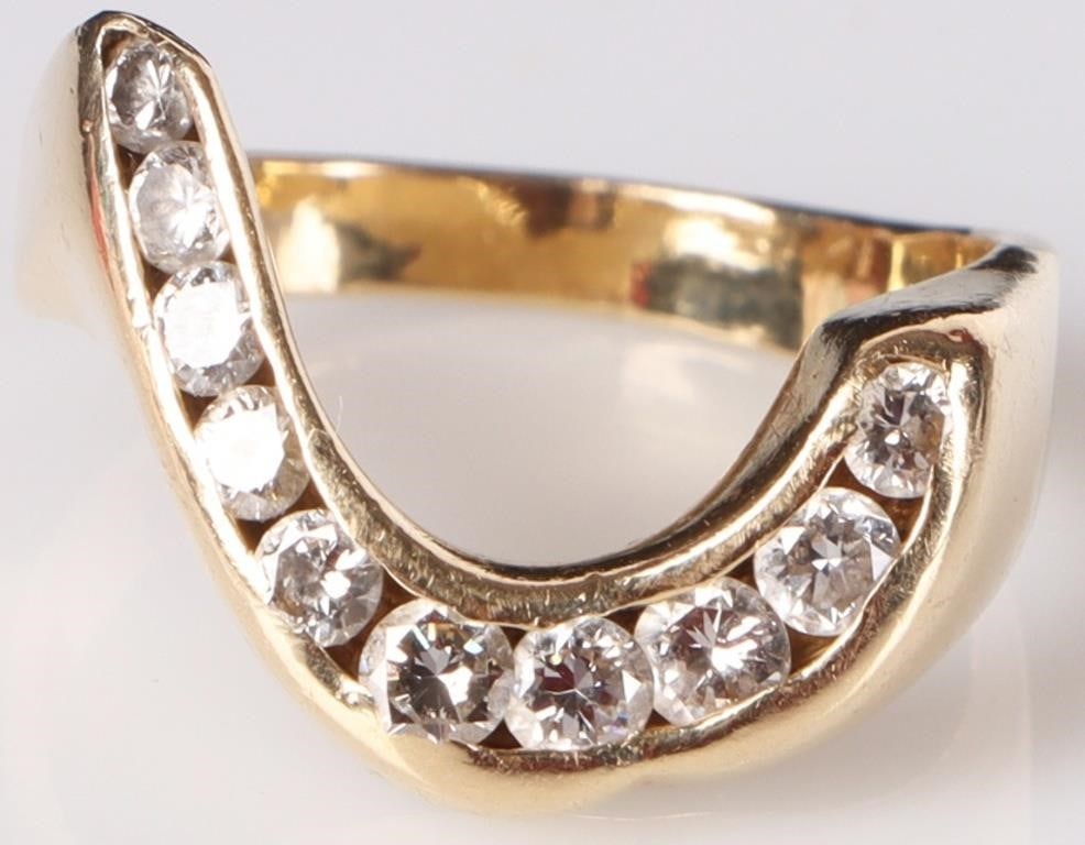 14K YELLOW GOLD LADIES RING W/ DIAMONDS IRREGULAR: 14K yellow gold ladies ring with ten round-cut diamonds (0.03CT - 0.071CT, 0.6CTW) lined along an irregular hook-shaped face. Includes an Arnold Jewelers insurance appraisal report. Stone Type: Diamon
