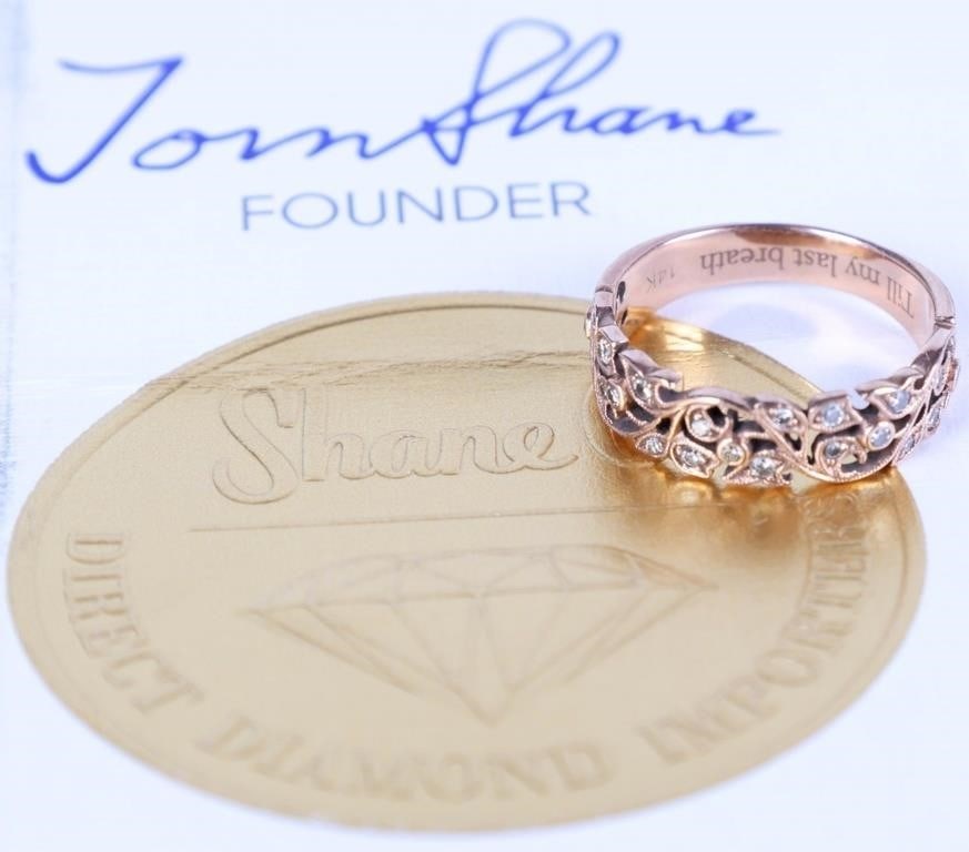 14K ROSE GOLD LADIES WEDDING RING W/ 21 DIAMONDS: 14k rose gold ladies wedding ring. The piece is sculpted with vining patterns across the face. Set across it are twenty-one small round-cut diamonds (0.2ctw). Includes an appraisal by Shane Co. Stone 