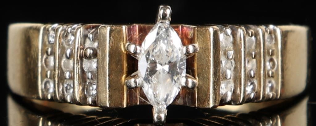 14K YELLOW GOLD LADIES RING W/ BRILLIANT DIAMONDS: 14k yellow gold ladies ring with a brilliant 0.15ct marquise-cut center diamond flanked by eighteen 0.01ct round-cut accessory diamonds (nine on either side). The ring itself is in an Art Deco style. 