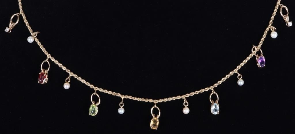 14K YELLOW GOLD ASSORTED GEM LADIES NECKLACE: 14K yellow gold assorted gem ladies necklace. Gemstones to include one 0.40CT oval cut garnet, peridot, citrine, blue topaz, amethyst, and two 0.05CT round cut diamonds. Stone Type: Assorted Weight: 9