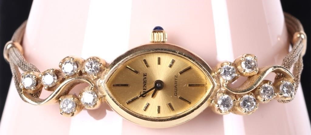 14K YELLOW GOLD DIAMOND GENEVE QUARTZ LADIES WATCH: 14K yellow gold diamond Geneve Quartz ladies wristwatch to include a golden dial, blue stone inset on the crown, and a 1/40th 10K yellow gold filled band. Gemstones to include twelve 0.07CT round cut 