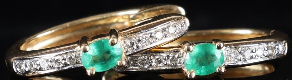 14K YELLOW GOLD LADIES EARRINGS W/ EMERALD & DIA: Pair of 14k yellow gold ladies elliptical hoop earrings, each of which feature a 0.05ct oval-cut emerald center stone flanked by ten melee diamonds (five above and five below). The areas around the me