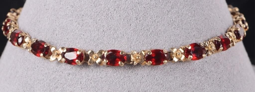 14K YELLOW GOLD LADIES BRACELET W/ GARNET STONES: 14k yellow gold ladies bracelet with one 0.25ct oval-cut garnet gemstone on each of the seventeen links. Stone Type: Garnet Weight: 6.1 grams Size: 8.5" long Condition: See pictures.
