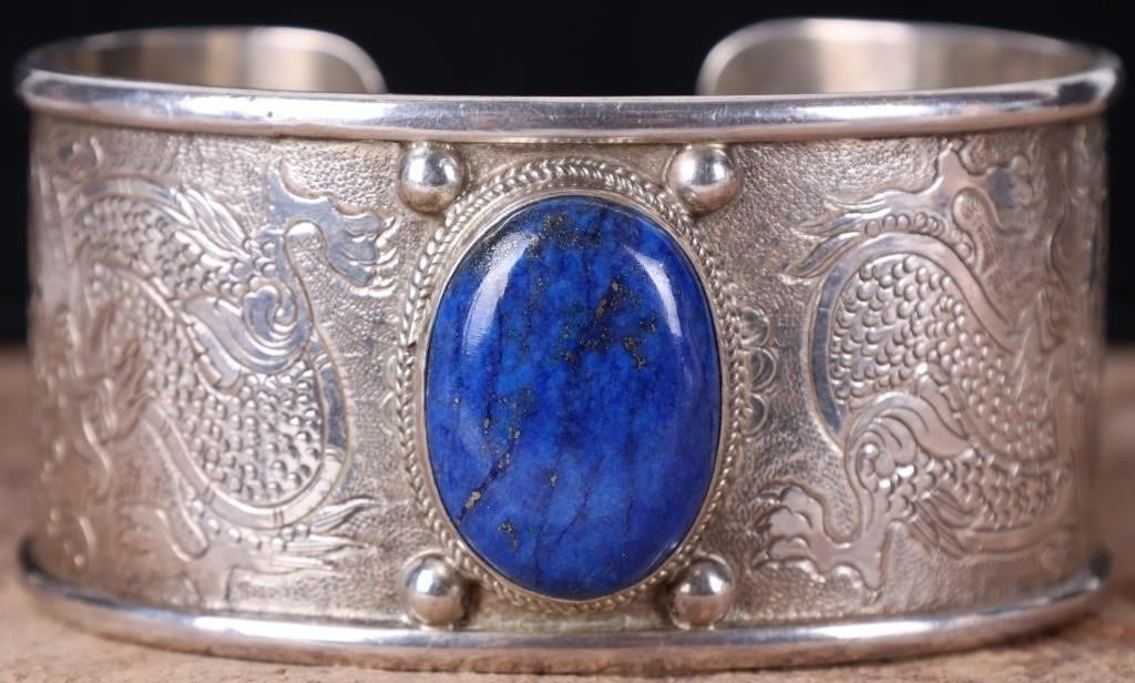 STERLING SILVER & BLUE LAPIS WIDE CUFF BRACELET: Sterling silver & blue lapis wide cuff ladies bracelet. This cuff bracelet has a beautiful dragon etching. It is stamped PTI 925 Nepal. This stamps indicates a traditional, handcrafted piece crafted