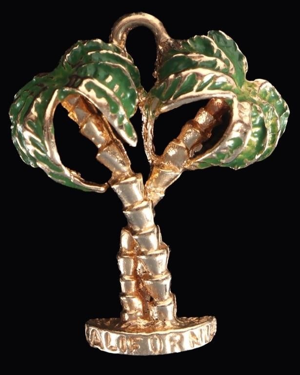 14K YELLOW GOLD CALIFORNIA PALMS SOUVENIR PENDANT: 14k yellow gold souvenir pendant of a pair of palm trees with the word 'California' etched on the base. The palm leaves are colored with a green enamel. Weight: 2.92 grams Size: 22.75 x 18.7mm
