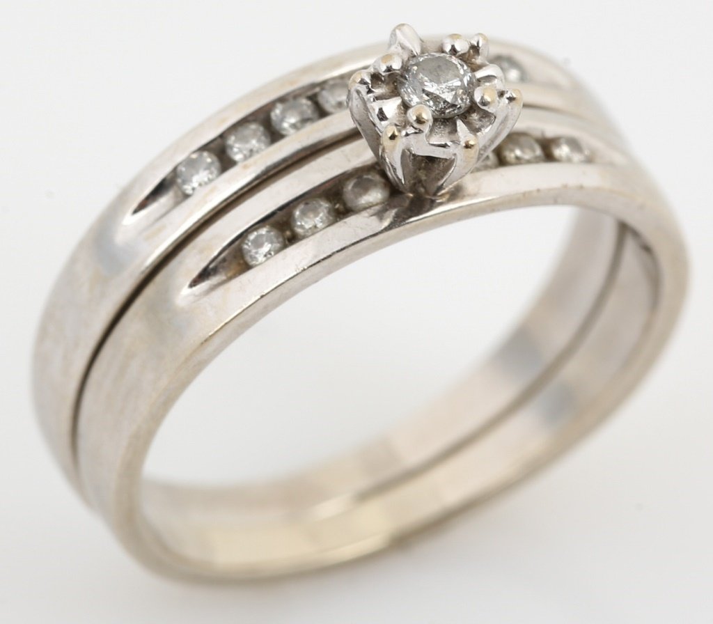 LADIES 10K WHITE GOLD DIAMOND WEDDING SET: LADIES 10K WHITE GOLD DIAMOND WEDDING SET Ladies 10K white gold diamond wedding set with an approximate .03 ct round diamond in the solitaire and three .01 ct round diamonds on either side of the cent