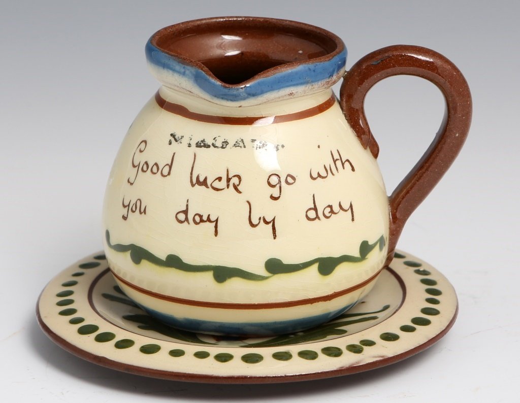 ALLER VALE TORQUAY MOTTO POTTERY CREAMER & SAUCER: ALLER VALE TORQUAY MOTTO POTTERY CREAMER & SAUCER Antique Aller Vale Torquay pottery creamer, 3", and saucer, 4.5"; Creamer reads "Good luck go with you day by day" and the N1 pattern saucer reads "Gu
