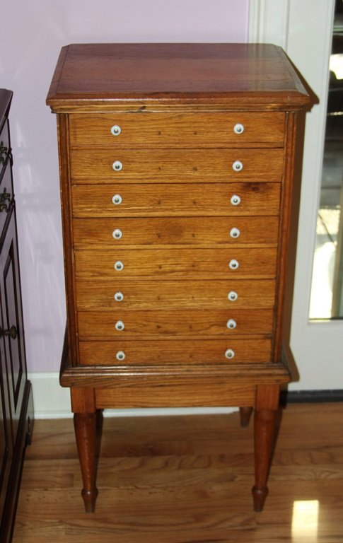 OAK SILVERWARE CHEST: OAK SILVERWARE CHEST Made in the USA by the Florence Company out of Florence, MA. Has 8 drawers with white porcelain pulls. Drawers have anti-tarnish cloth in them. Size: 20x16.5x40" Shipping / Pickup