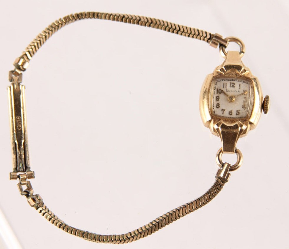 LADIES BULOVA 14K YELLOW GOLD CASE WATCH: LADIES BULOVA 14K YELLOW GOLD CASE WATCH dated 1949, inscribed "Class 2" on back of case. Stainless steel band. Type: Wristwatch Weight: 12.9g Shipping / Pickup: We Can Ship This Item Lot Location: #1