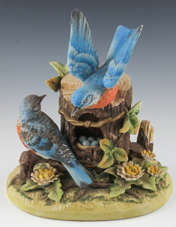 GORHAM PORCELAIN BIRD STATUE: GORHAM PORCELAIN BIRD STATUE The statue depicts two blue birds sitting on a log with a nest and eggs. Marked on the underside. Size: 9" Shipping / Pick-Up: We Can Ship This Item Lot Location: #1 - Man