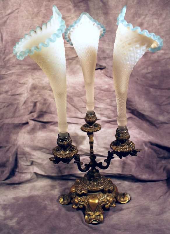 China/Glassware: Victorian Brass 3 Arm Epergne with Satin Ruffled Ribbon Blue Vases. Each Vase offers "Jack in the Pulpit" Design w/ patterned Diamond and Dot Necks. Overall H18"x 12"W