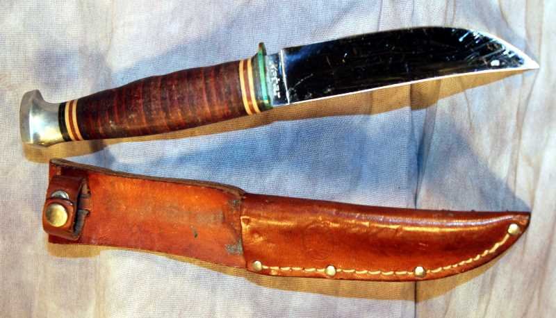 Vintage Kabar Hunting Knife: Kabar with original sheath, 4.25" blade, scratches from sharpening, shiny chrome blade, leather washer grip.
