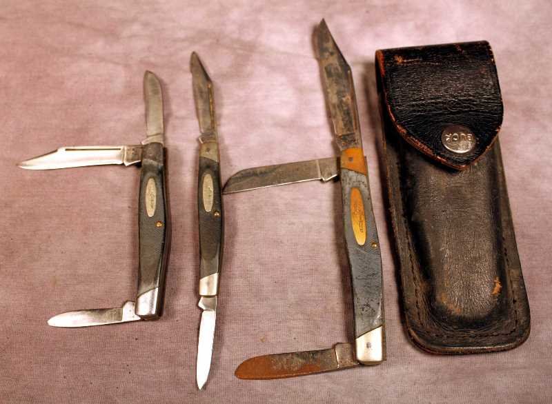 3 Buck Folding Knives, 301, 303, 309: Vintage used knives in good condition. All are marked BUCK. The longest blade is approx. 3". Clot comes with a Buck black leather belt case, (fits a folding Buck #110).