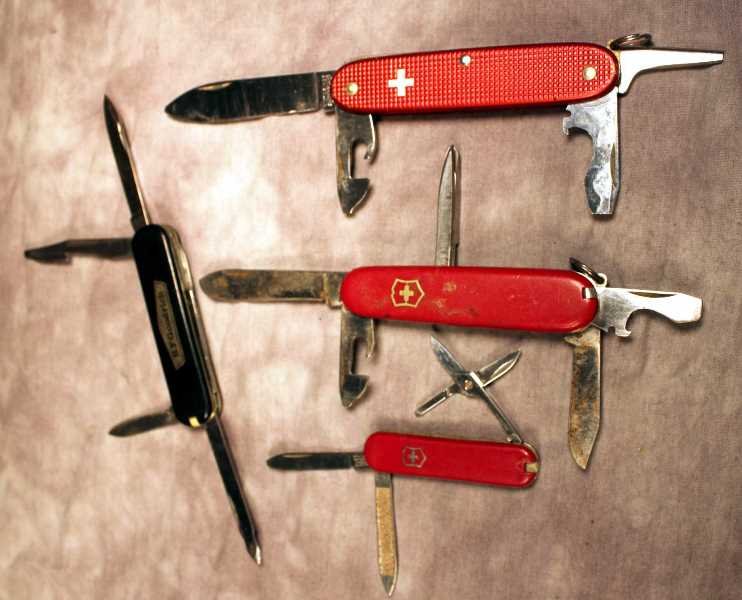 4 Swiss Army Pocket Knives, B.F. Goodrich: B.F. Goodrich advertising knife, Victorinox and 3 other Swiss knives. Longest blade is approx. 2.75".