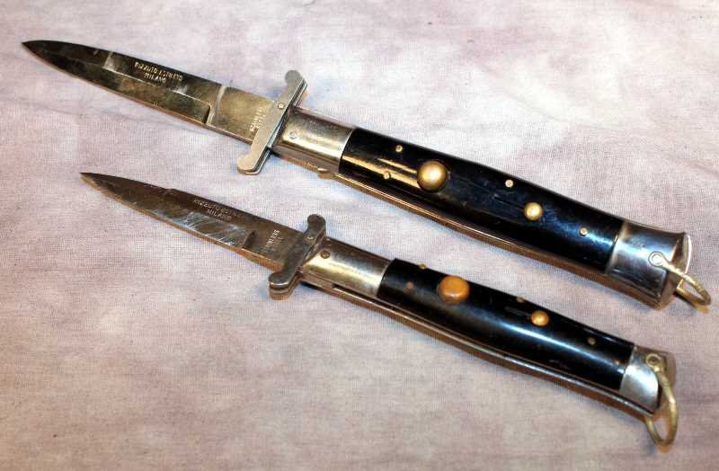 2 Rizzuto Estileto Milano Switchblades: Stainless steel blades and swing guards, black plastic grips (larger knife has a crack in the grip). Both are marked the same. Smallest blade is approx. 3" and the larger is approx. 3.75". Mechanism d