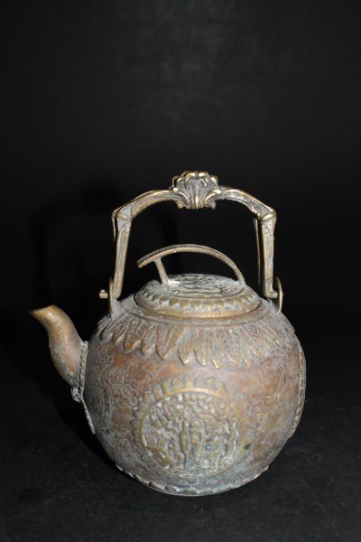 Chinese Bronze Teapot: Of spherical form, centering four medallions depicting Shou in relief over the chased ground, surmounted by the lid with conforming decoration and shaped handles. Size : 5.5" H to top of the lid.