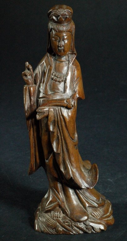 Highly Carved Huangyang Wood Guanyin: Depicting a standing Guanyin in flowing robes, cradling a ruyi scepter in one arm, the other oustretched hand clutching a pearl._x000D_ Size : 7 1/2" H
