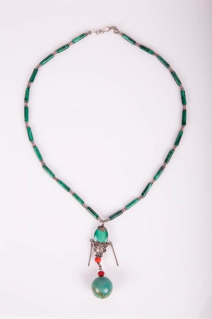 A MALACHITE AND TURQUOISE NECKLACE: Qing dynasty, malachite and silver pendant hangs a turquoise bead; 19 5/8 in. l