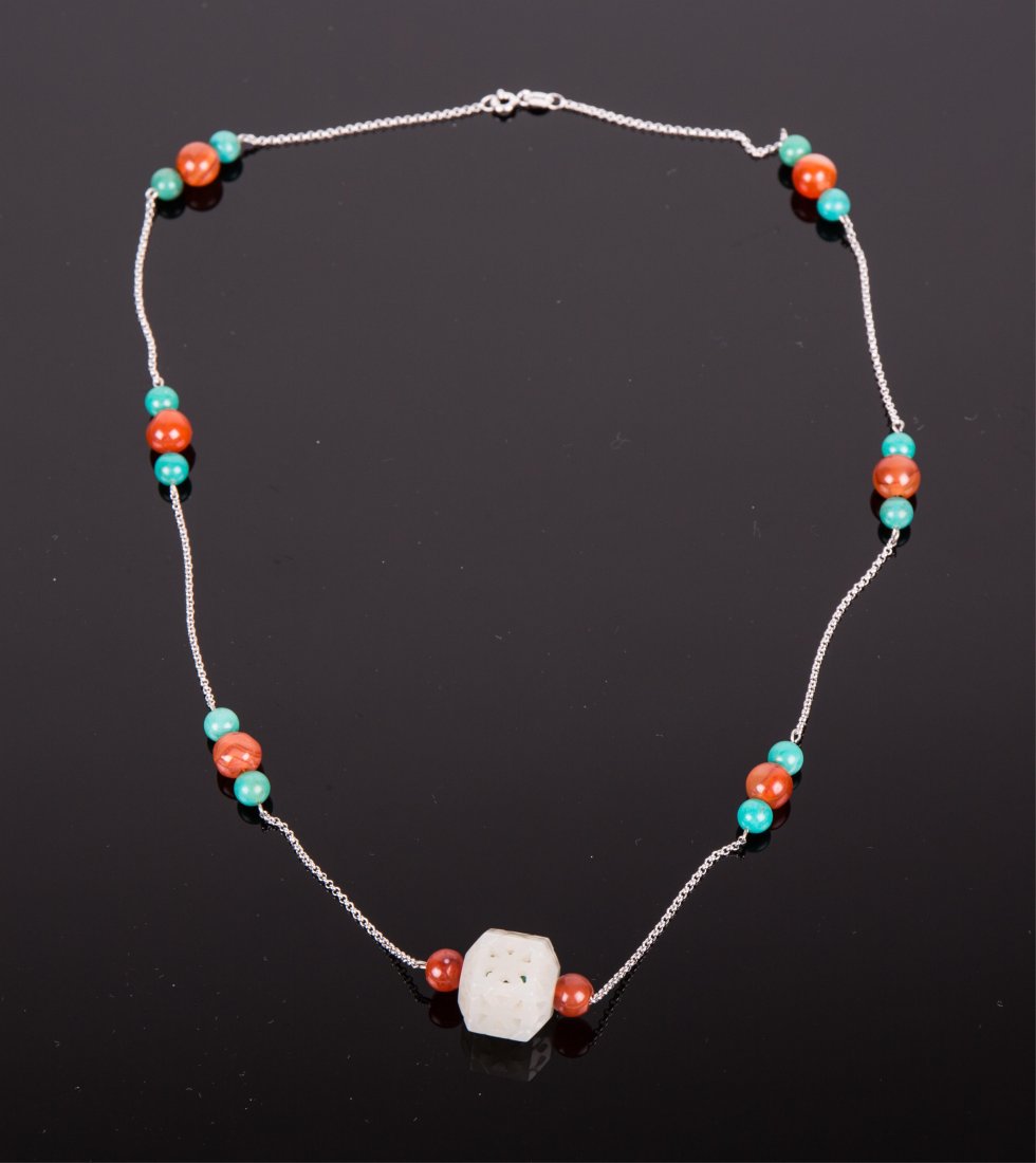 SILVER NECKLACE WITH JADE, TURQUOISE AND AGATE: Qing dynasty; a hexagonal white jade beads carved in open work pendant; white jade pendant; 21 5/8 in. l