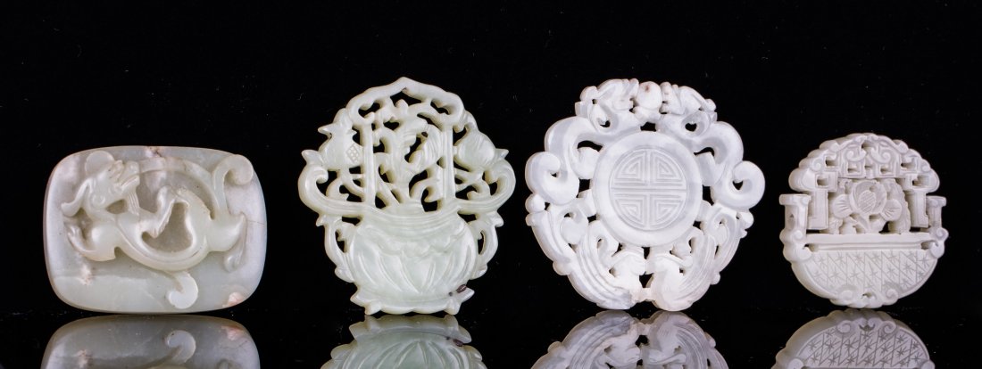 FOUR PIECES CHINESE JADE PLAQUES: Qing dynasty; biggest (2 5/8 in.), smallest (1 5/8 in.)