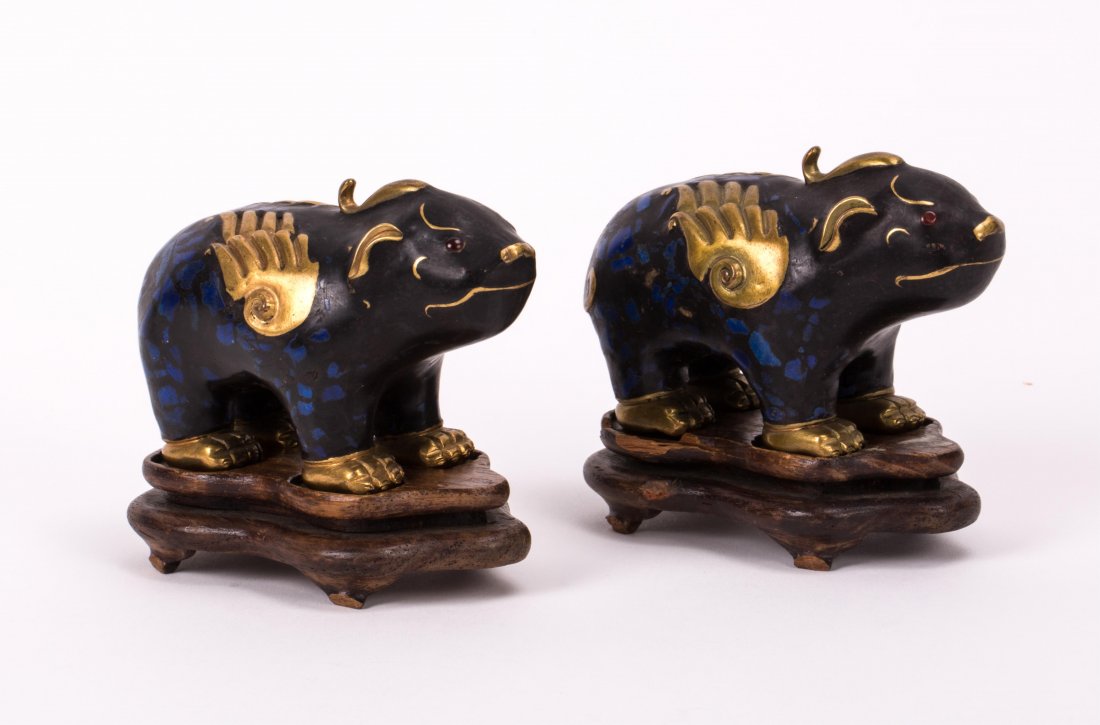 A PAIR OF ENAMELED BEAST WITH HARDWOOD BASE: 19th / 20th century; 3 3/4 in. h, 4 1/2 in. w