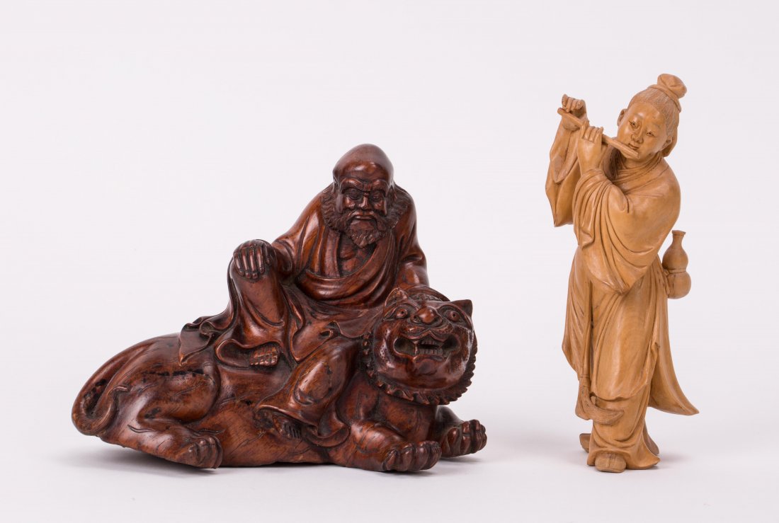 TWO CHINESE HARDWOOD CARVINGS: 19th / 20th century; one Lohan on tiger, another boy playing flute; 1st one (5 1/4 in. h, 7 in. w), 2nd one (6 1/2 in. h)