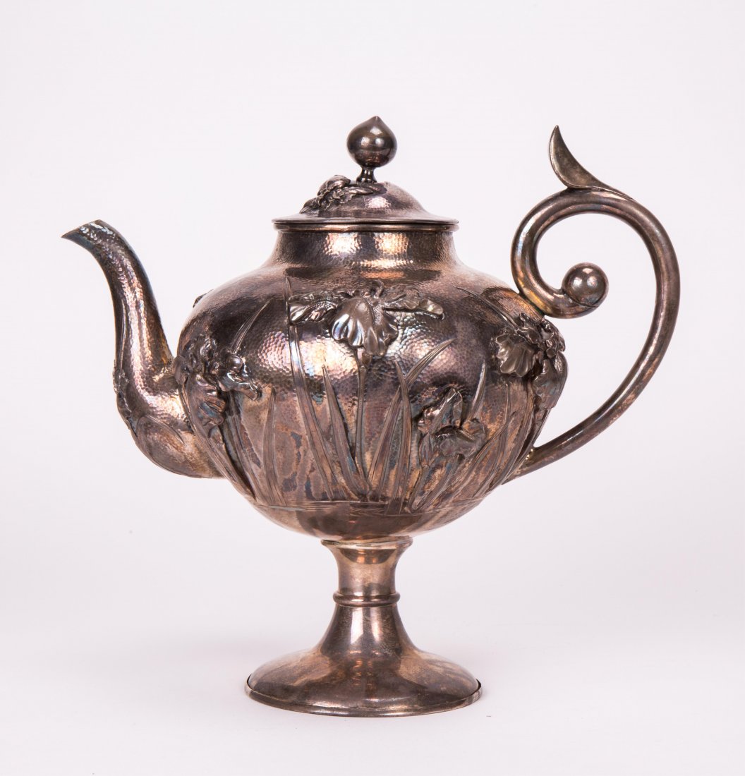 JAPANESE SILVER TEAPOT WITH IRIS MOTIF: 19th / 20th century; 9 in. h