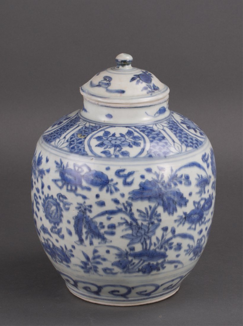 CHINESE MING BLUE WHITE PORCELAIN COVERED VASE: missing a piece on right hand and a few cracks; lotus vine motif; 10 1/2 in. h