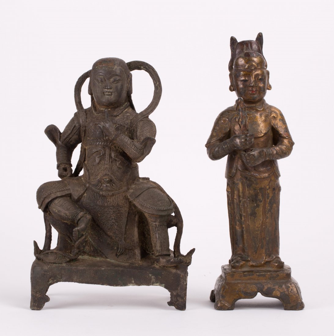 TWO CHINESE MING BRONZE FIGURINES: one standing officer, another seated Daoist figurine; 10 1/2 in. h, 10 in. h
