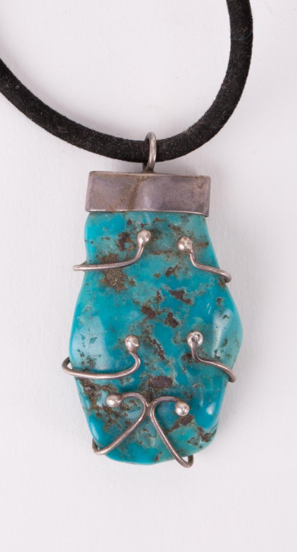 A TURQUOISE PENDANT: pendant (1 3/4 in. h, 1 in. w)