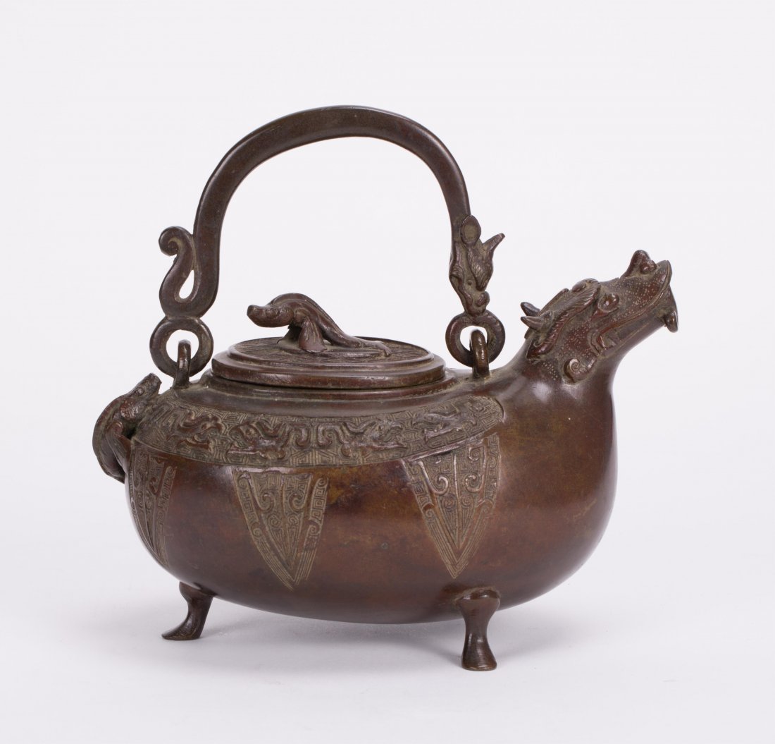 CHINESE BRONZE TEAPOT WITH DRAGON HEAD SPOUT: 18th/19th century; 6 in. h by 6 1/2 in. w