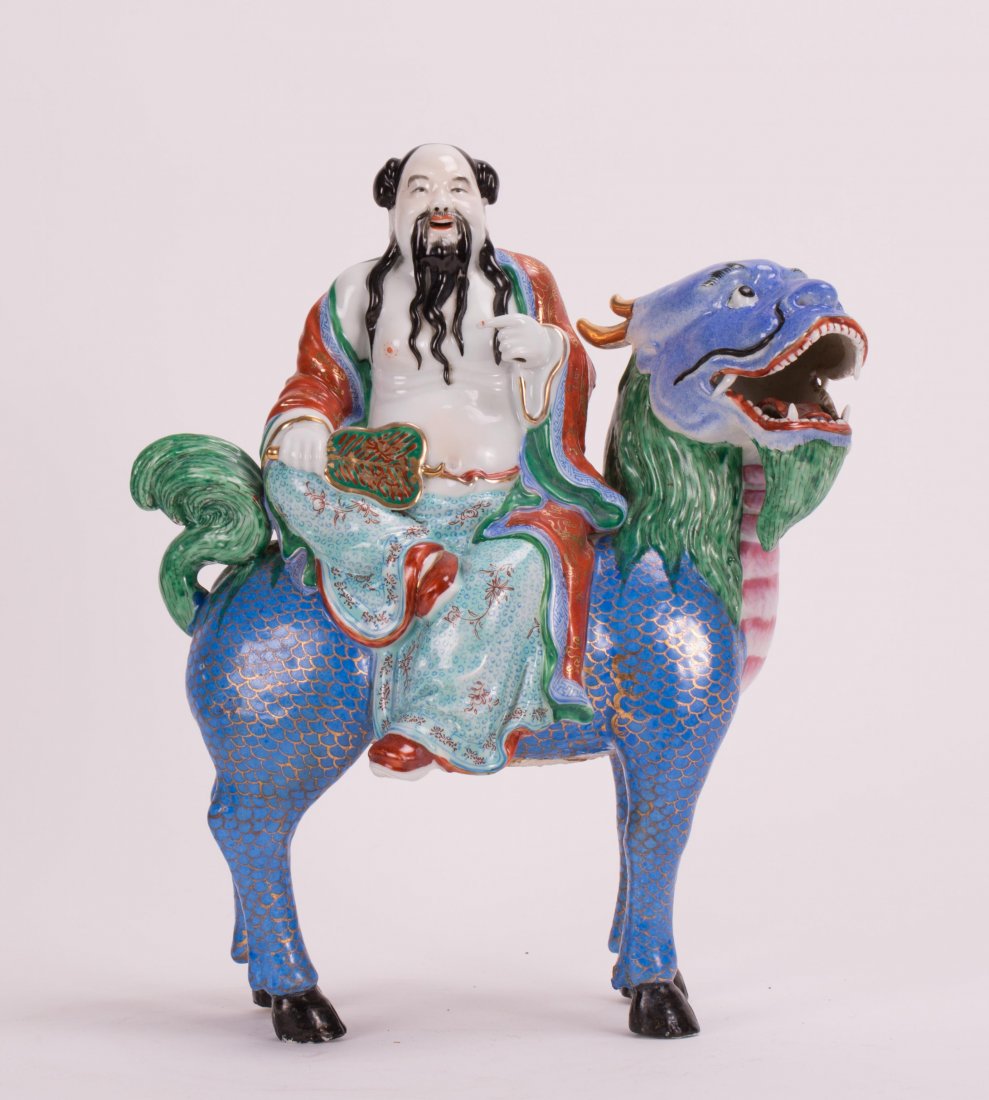 CHINESE FAMILLE ROSE PORCELAIN IMMORTAL ON LION: 19th/20th century; 11 1/2 in. h by 9 in. w