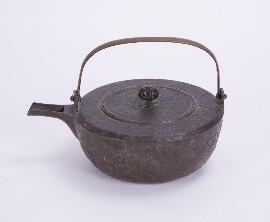 JAPANESE BRONZE TEAPOT WITH FLORAL MOTIF: 19th cen; 5 7/8 in. diameter, 7 5/8 in. w