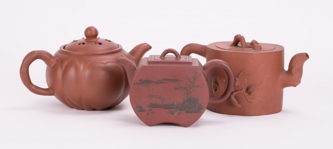 THREE CHINESE YIXING ZISHA TEAPOT: smallest (4 in. h, 6 in. w), middle (4 1/4 in. h, 7 1/2 in. w), largest (4 1/2 in. h, 7 1/2 in. w)