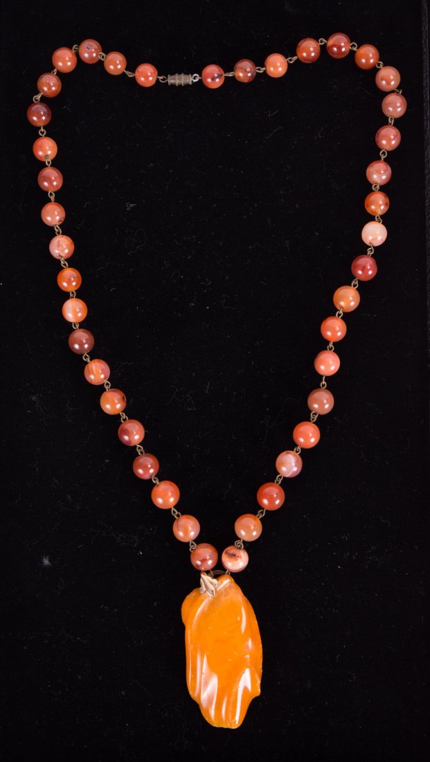CHINESE AGATE AND AMBER NECKLACE: Chinese Agate and Amber Necklace. 20th century; 13 in. l (unstrung w/o pendant), 16 in. l (unstrung w/ pendant), 3/8 in. w (bead size); 3.45 oz / 97 g