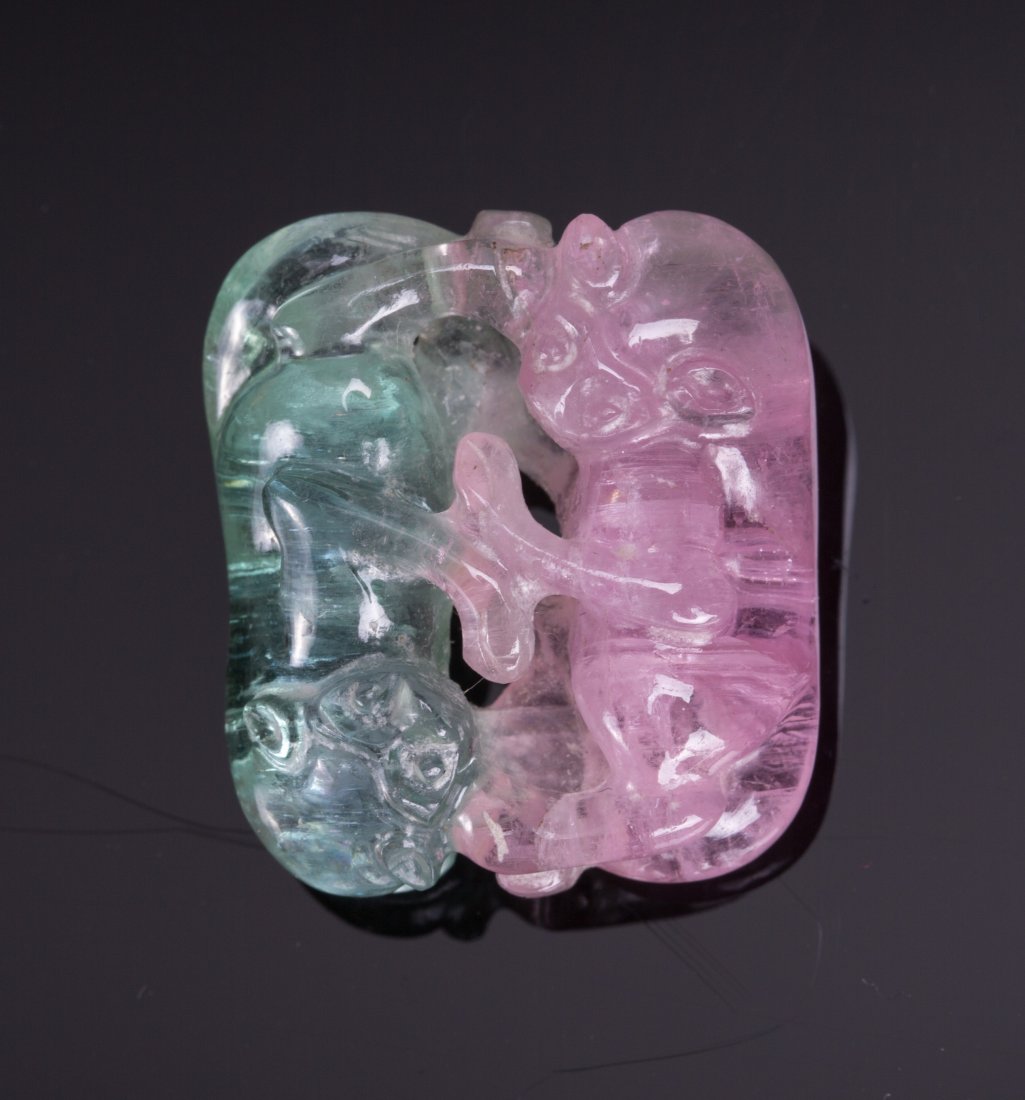 TWO TONE CHINESE TOURMALINE PENDANT OF FOOLIONS: Two Tone Chinese Tourmaline Pendant of Foolions. 20th century; weight (0.34 oz / 10.8 g); 1 by 3/4 in.. Provenance: An Old Long Island Estate Collection