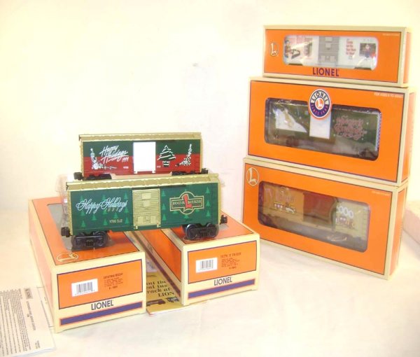 ABT: 5 Mint Lionel Christmas Box Cars/OBs: Paul V. Ambrose and Drew J. Bauer present: These are five Christmas Box Cars that Lionel made a few years ago. Included are the #16272 1997 Christmas Box Car, the #26272 2000 Christmas Box Car, the #2