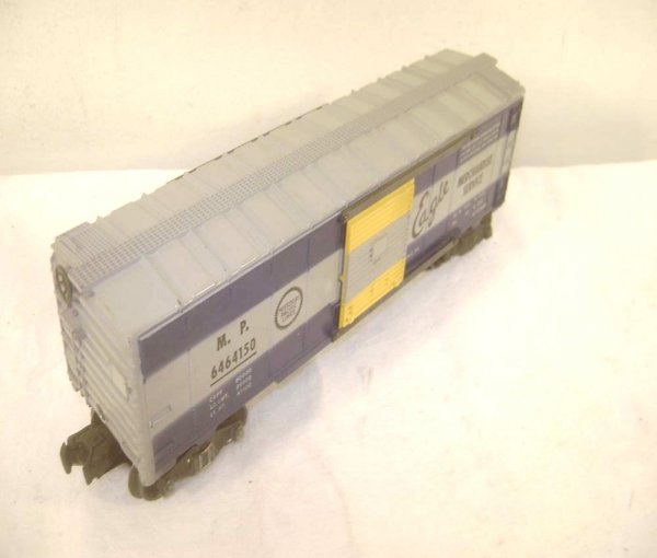 ABT: Lionel #6464-150 Missouri Pacific Box Car/Str: Paul V. Ambrose and Drew J. Bauer present: This is the #6464-150 Missouri Pacific Box Car that Lionel made in the middle 1950s. Early Production, Type IIA body scarce Stripe Doors; right-side Eagle wi