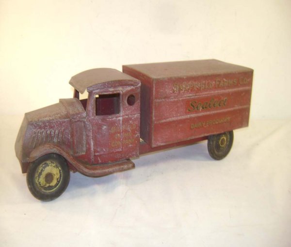 ABT: Red 21-inch Sheffield Farm Co. Truck: Paul V. Ambrose and Drew J. Bauer present: This is a Red Sheffield Farm Co. Truck from circa the 1930s. It measures approximately 21-inches long and 6 1/2-inches high with most original Decals. Our Op