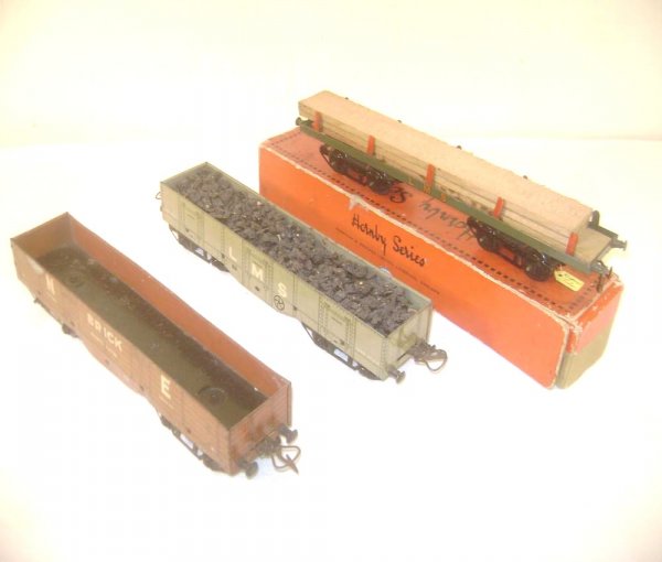 ABT: Hornby Lumber Wagon & 2 Open Goods Trucks/OB: Paul V. Ambrose and Drew J. Bauer present: This is a Lumber Wagon with original Lumber and two Open Goods Trucks that Hornby made in O-gauge circa the 1930s. All models are elongated and measure appro