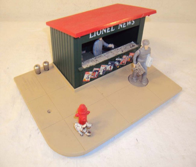 ABT: Lionel #128 Animated Newsstand: Paul V. Ambrose and Drew J. Bauer present: This is the #128 Animated Newsstand that Lionel made in the 1950s. Our Opinion is that it is generally in Excellent Minus Condition; will clean nicely. No Bo