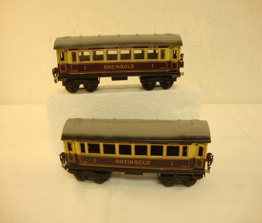 ABT: 2 Marklin O Gauge #17580 Mitropa/Rheingold Coa: Paul V. Ambrose and Drew J. Bauer present: These are two purple #17580 Mitropa/Rheingold 1st Class Coaches that Marklin made in O gauge circa the 1930s. They measure approx. 10-inches in length; note 