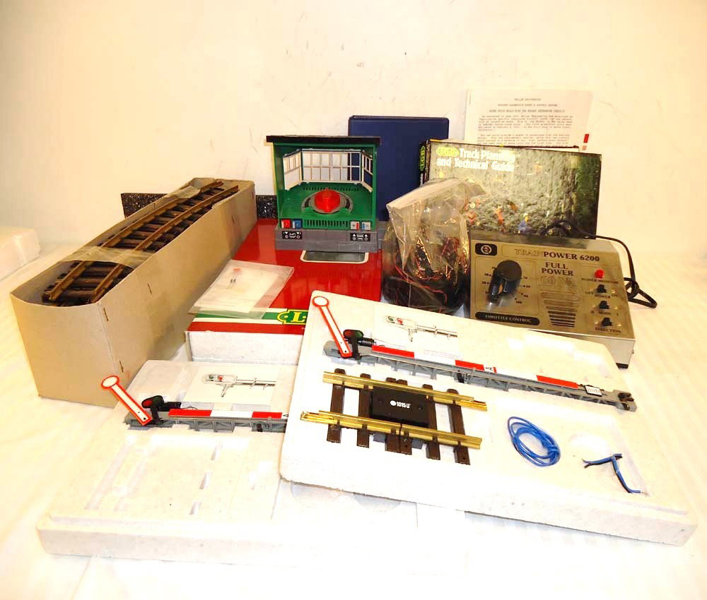ABT: Large Lot of LGB Assorted Items: Paul V. Ambrose and Drew J. Bauer present: This is a LGB Mixed lot with Controllers, 12 pieces of track, guides/book, semaphores, lamp post(bottom half only). Please review the pictures carefully. Ple