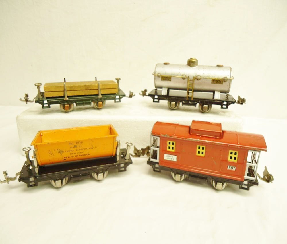 ABT: Lionel #804/807/809/831 Rolling Stock: Paul V. Ambrose and Drew J. Bauer present: These are the #804 Tank Car, #807 Caboose, #809 Ore Car, and #831 Flat Car w/Lumber that Lionel made Pre War. No Boxes. Please add $16.00 for US-48 Shipping 