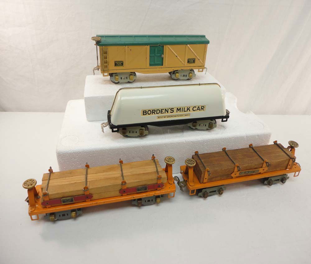 ABT: 4 Great AF O Gauge Rolling Stock Items: Paul V. Ambrose and Drew J. Bauer present: These are two #3216 Flat Cars w/Wood, Cream/Green Boxcar, and Borden's Milk Car That American Flyer made in O gauge in the 1930s. Our Opinion is that they av