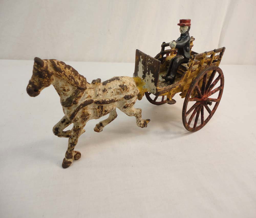 ABT: Old Cast-Iron Horse Drawn Wagon w/Man: Paul V. Ambrose and Drew J. Bauer present: This is a cast-iron Horse drawn Wagon with Driver from time long ago. The Carriage measures approx. 10 inches in length and 4.5 inches in height. Examine the