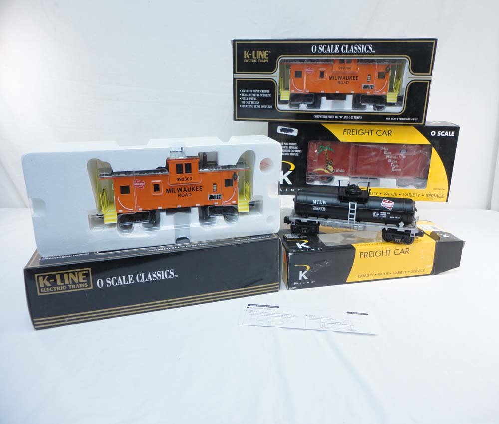 ABT: 4 Mint K-Line #613-1371/k631-1372/K765-2112 C: Paul V. Ambrose and Drew J. Bauer present: These are two #K613-1371 Milwaukee Road Extended Vision Cabooses, the #K631-1372 Milwaukee Tank Car, and the #K765-2112 Union Pacific Herbie Box Car that K-L