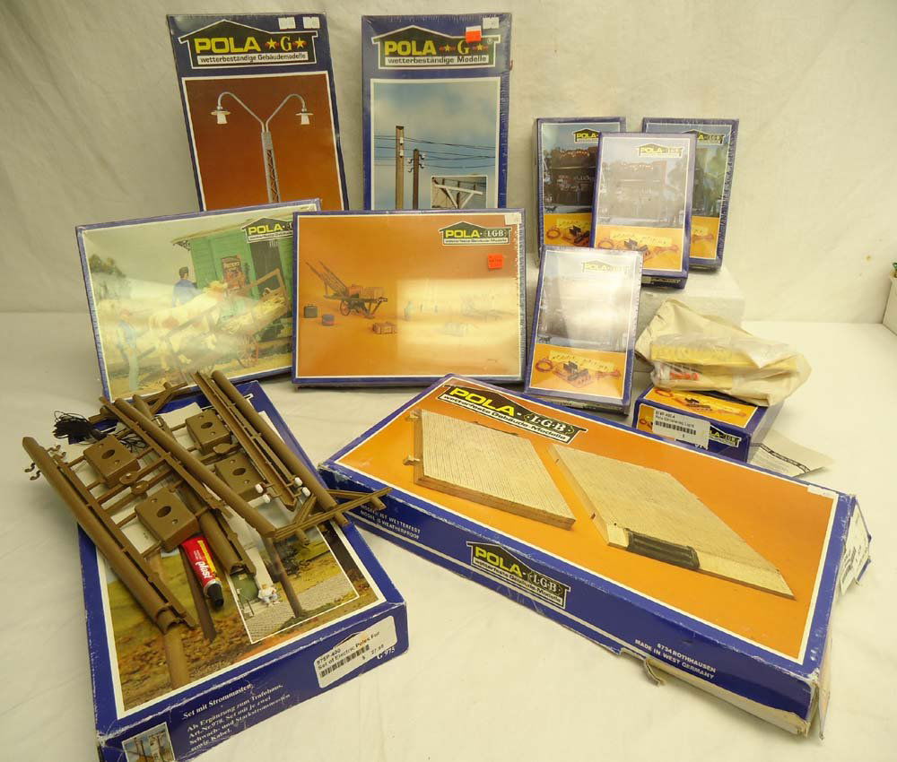 ABT: Pola/LGB G Scale: #974/G975/904/971/964/966 A: Paul V. Ambrose and Drew J. Bauer present: These are five #974 Circulating Light Sets, two #G975 Set of Electric Poles, the #904 Baseplate, the #971 Railway Yard Light, the #964 Station Cart & Luggage